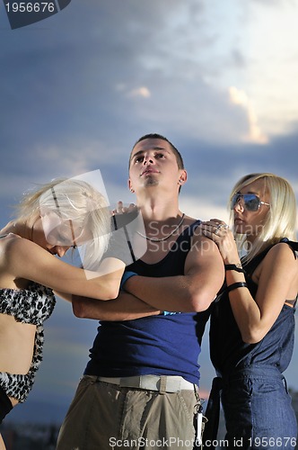 Image of romantic urban couple dancing on top of  bulding