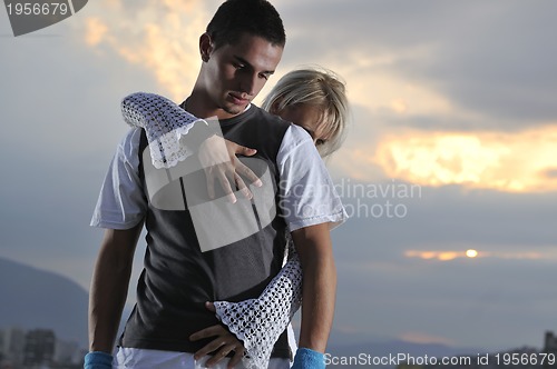 Image of romantic urban couple dancing outdoor