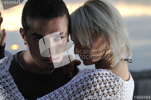 Image of romantic urban couple dancing on top of the bulding 