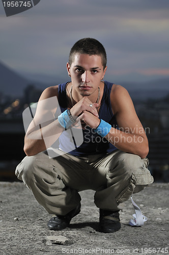 Image of urban style boy portrait in crouch pose