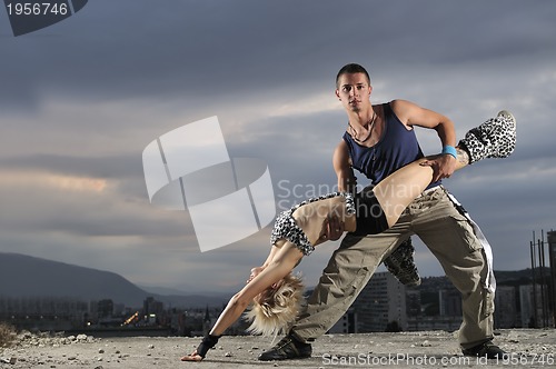 Image of romantic urban couple dancing outdoor