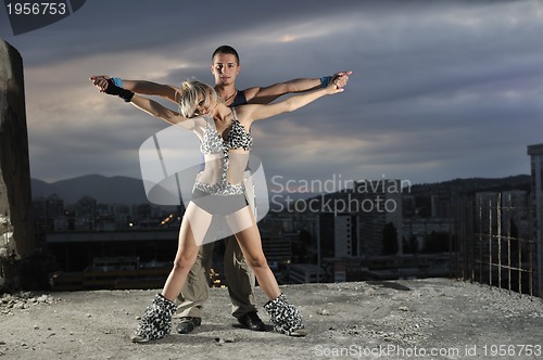 Image of romantic urban couple dancing outdoor