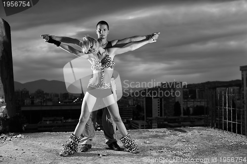 Image of romantic urban couple dancing outdoor