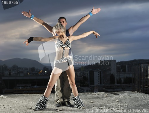 Image of romantic urban couple dancing outdoor