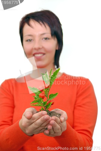 Image of Beautiful  girl holding young plant