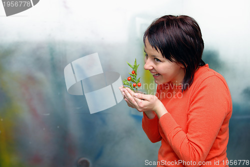 Image of Beautiful  girl holding young plant