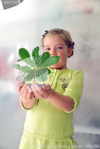 Image of little girl holding small plant