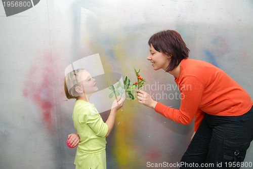 Image of Girl giving mother flowers