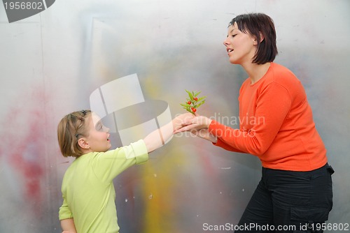 Image of Girl giving mother flowers