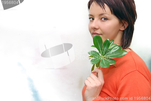 Image of Beautiful  girl holding young plant