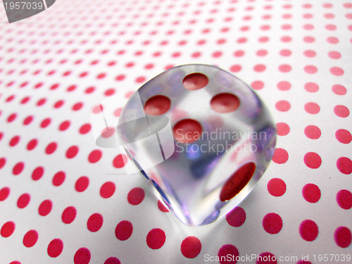 Image of gambling dice on red dotted background