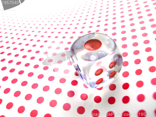 Image of gambling dice on red dotted background