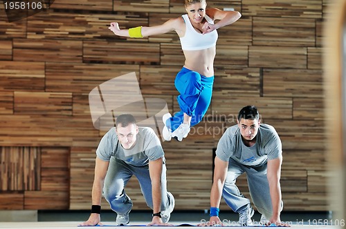 Image of young adults group in fitness club