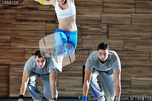 Image of young adults group in fitness club