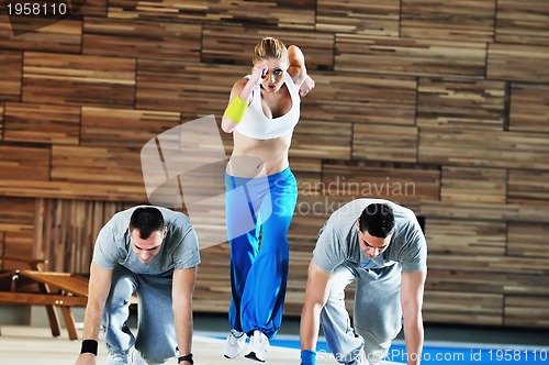 Image of young adults group in fitness club