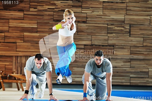 Image of young adults group in fitness club