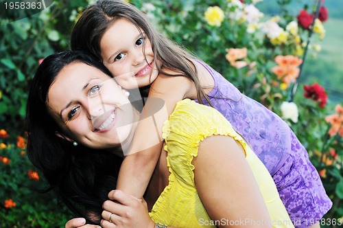 Image of happy mom and daughter outdoor