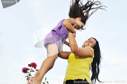 Image of happy mom and daughter outdoor