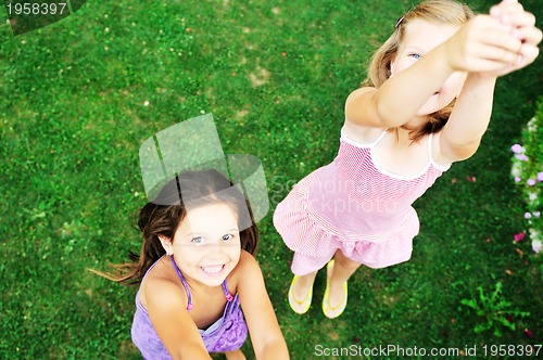 Image of two happy girls have fun outdoor 