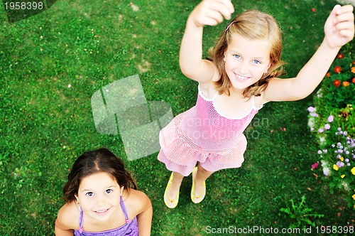 Image of two happy girls have fun outdoor 