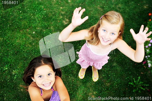 Image of two happy girls have fun outdoor 