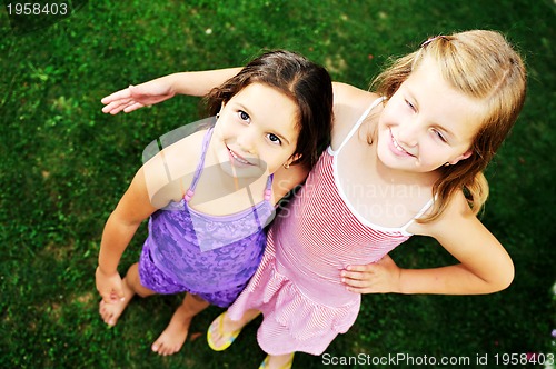 Image of two happy girls have fun outdoor 