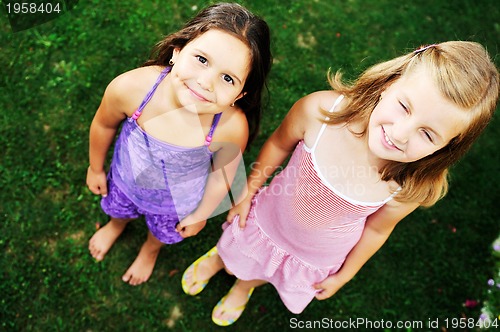 Image of two happy girls have fun outdoor 
