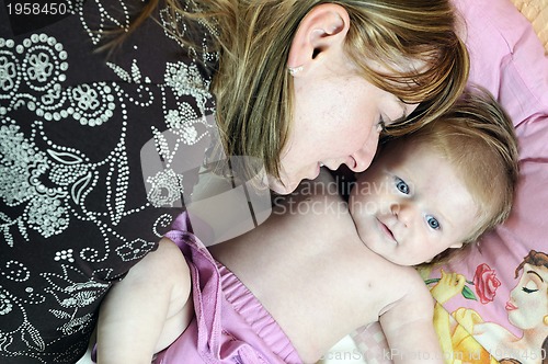 Image of beautiful blonde young mother and cute baby