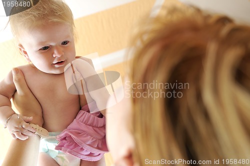 Image of beautiful blonde young mother and cute baby