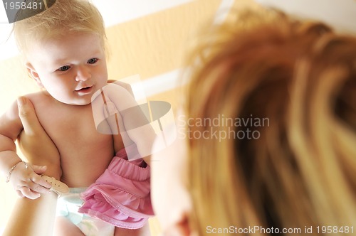 Image of beautiful blonde young mother and cute baby