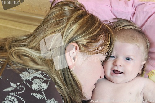 Image of beautiful blonde young mother and cute baby