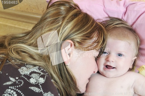 Image of beautiful blonde young mother and cute baby