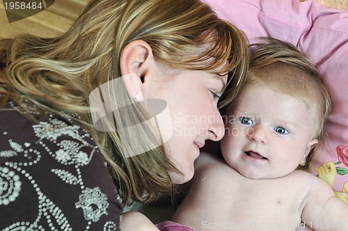 Image of beautiful blonde young mother and cute baby