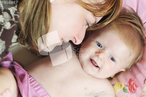 Image of beautiful blonde young mother and cute baby