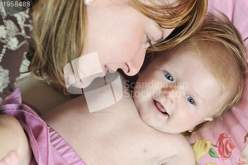 Image of beautiful blonde young mother and cute baby