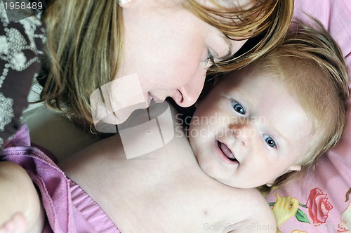 Image of beautiful blonde young mother and cute baby