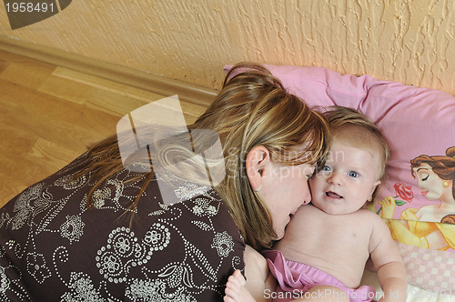 Image of beautiful blonde young mother and cute baby