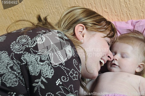 Image of beautiful blonde young mother and cute baby