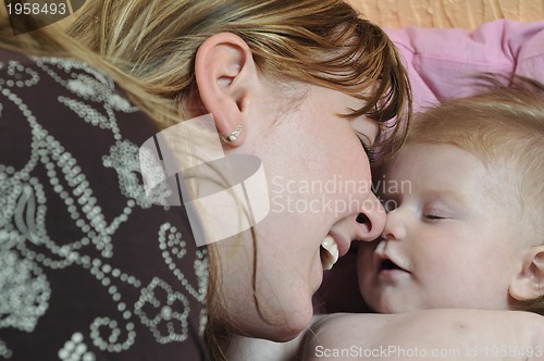 Image of beautiful blonde young mother and cute baby