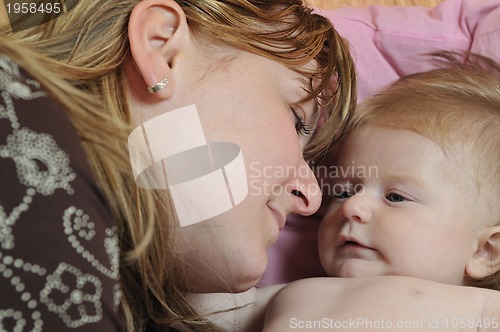 Image of beautiful blonde young mother and cute baby