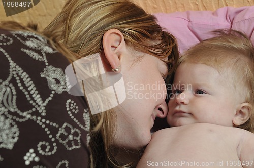 Image of beautiful blonde young mother and cute baby