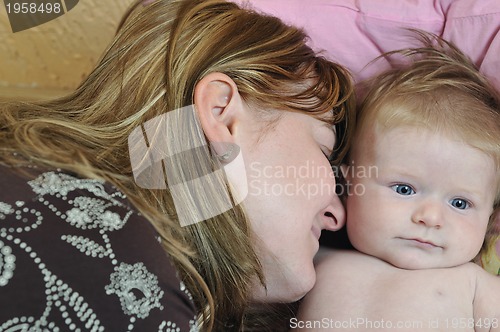 Image of beautiful blonde young mother and cute baby
