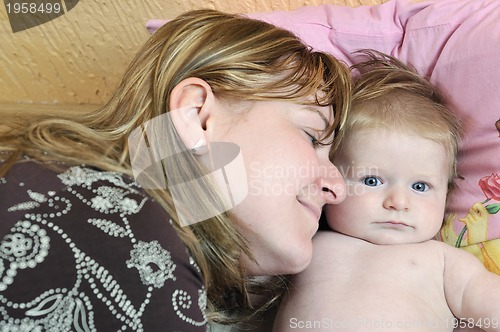 Image of beautiful blonde young mother and cute baby