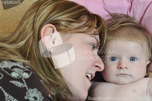 Image of beautiful blonde young mother and cute baby