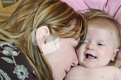 Image of beautiful blonde young mother and cute baby