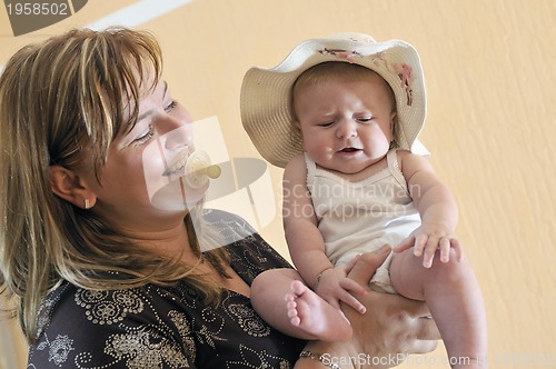 Image of beautiful blonde young mother and cute baby