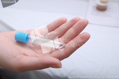 Image of test-tube in woman hand