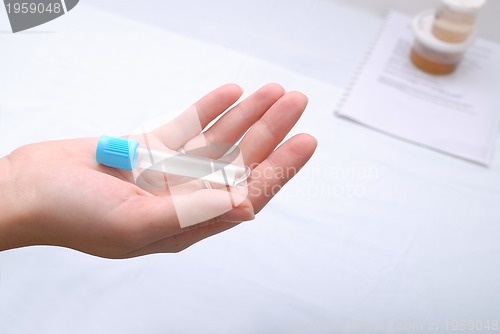 Image of test-tube in woman hand