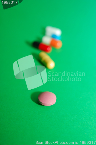 Image of pills on green background