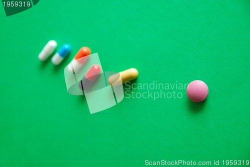 Image of pills on green background